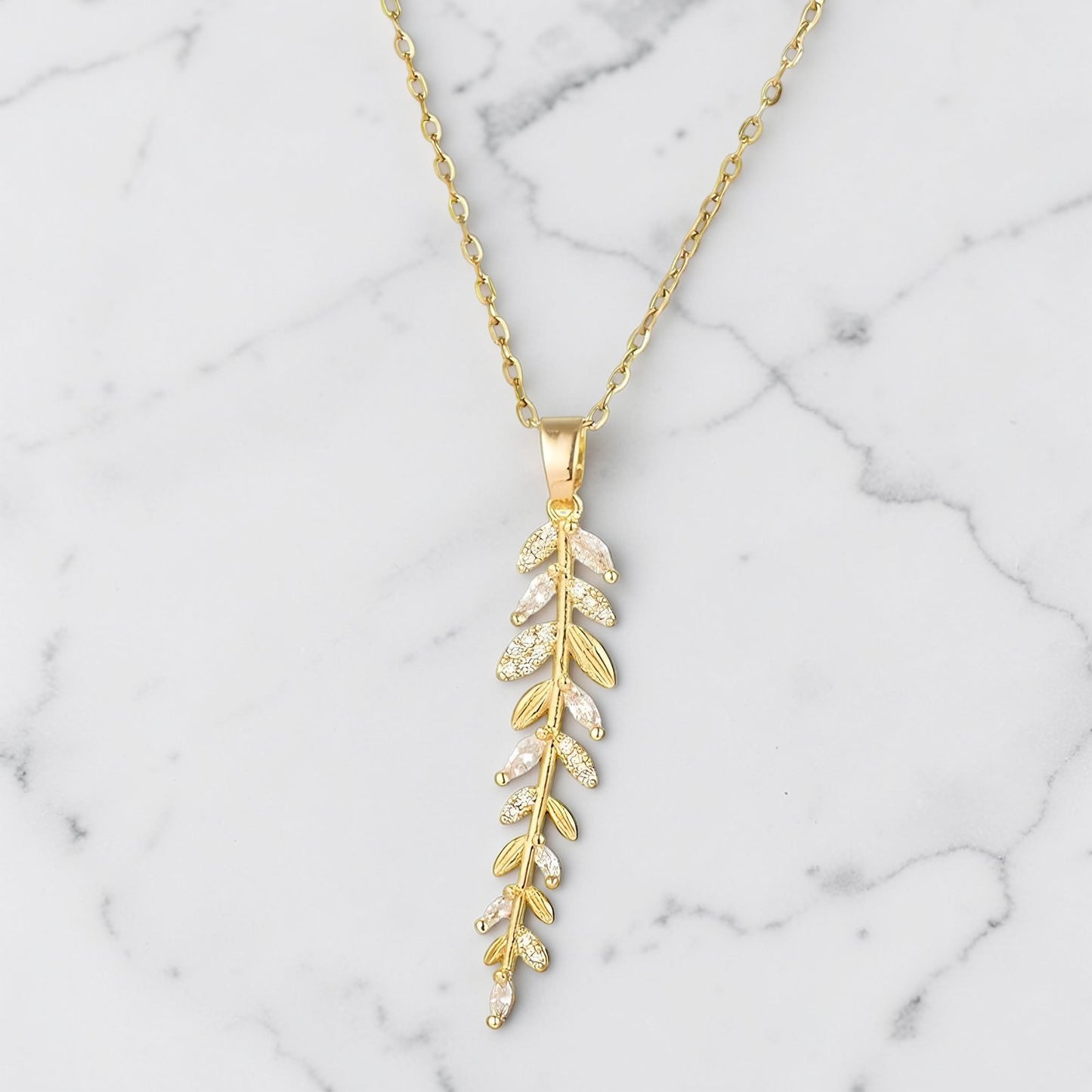 Gold Alina Leaf Necklace with vertical vine design and cubic zirconia accents