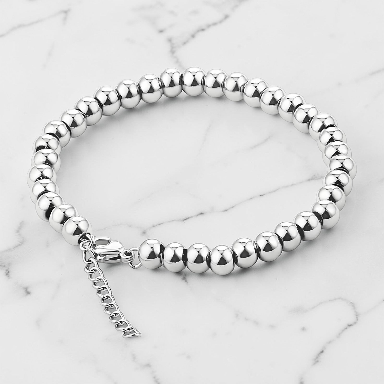 Silver beaded bracelet with polished round beads and a lobster claw clasp.