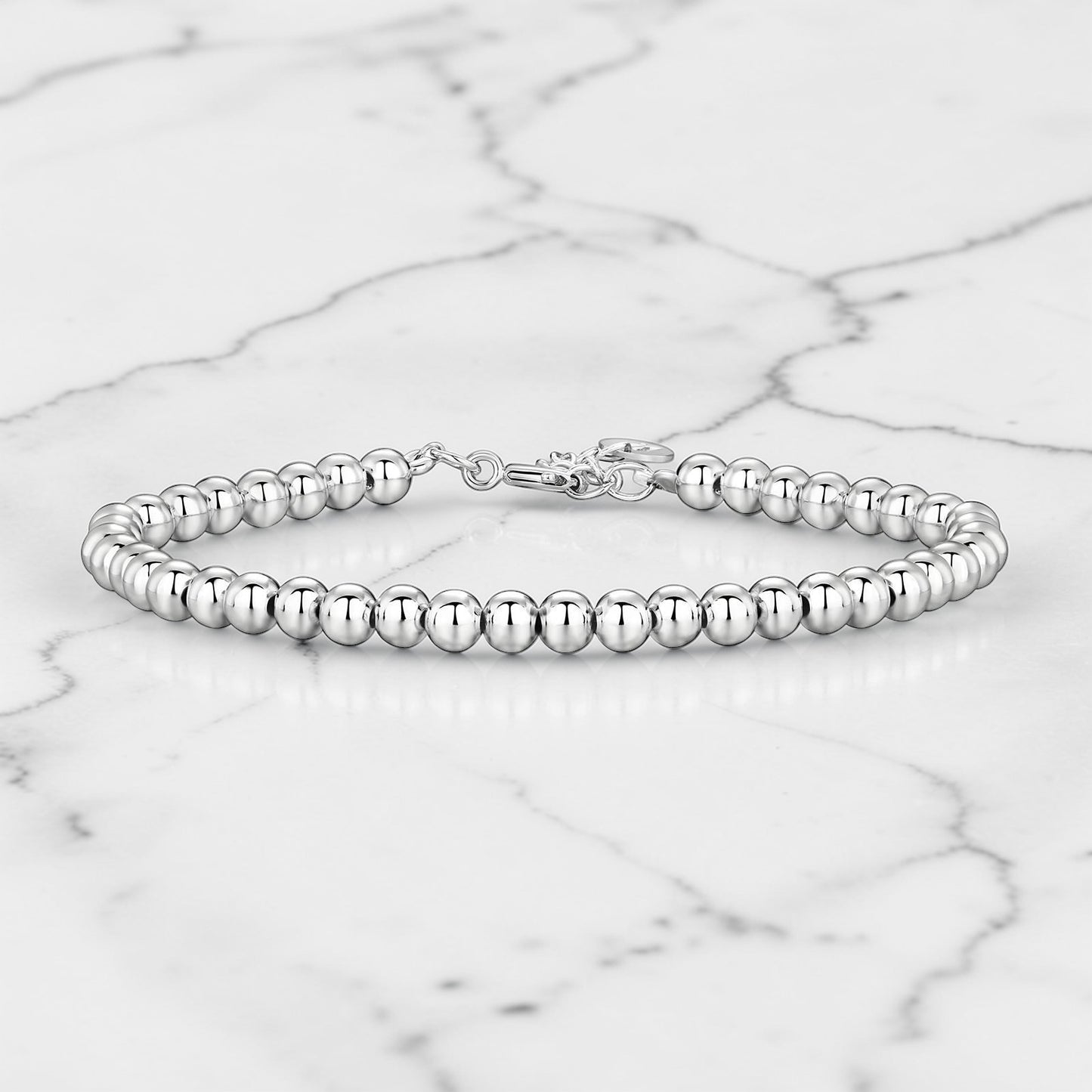 Silver beaded bracelet with polished round beads and a lobster claw clasp.