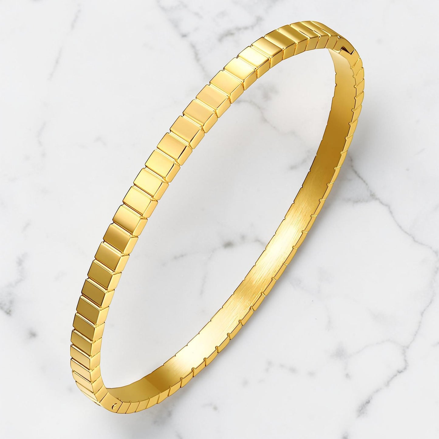 Gold textured bangle with a geometric prism pattern and polished finish.
