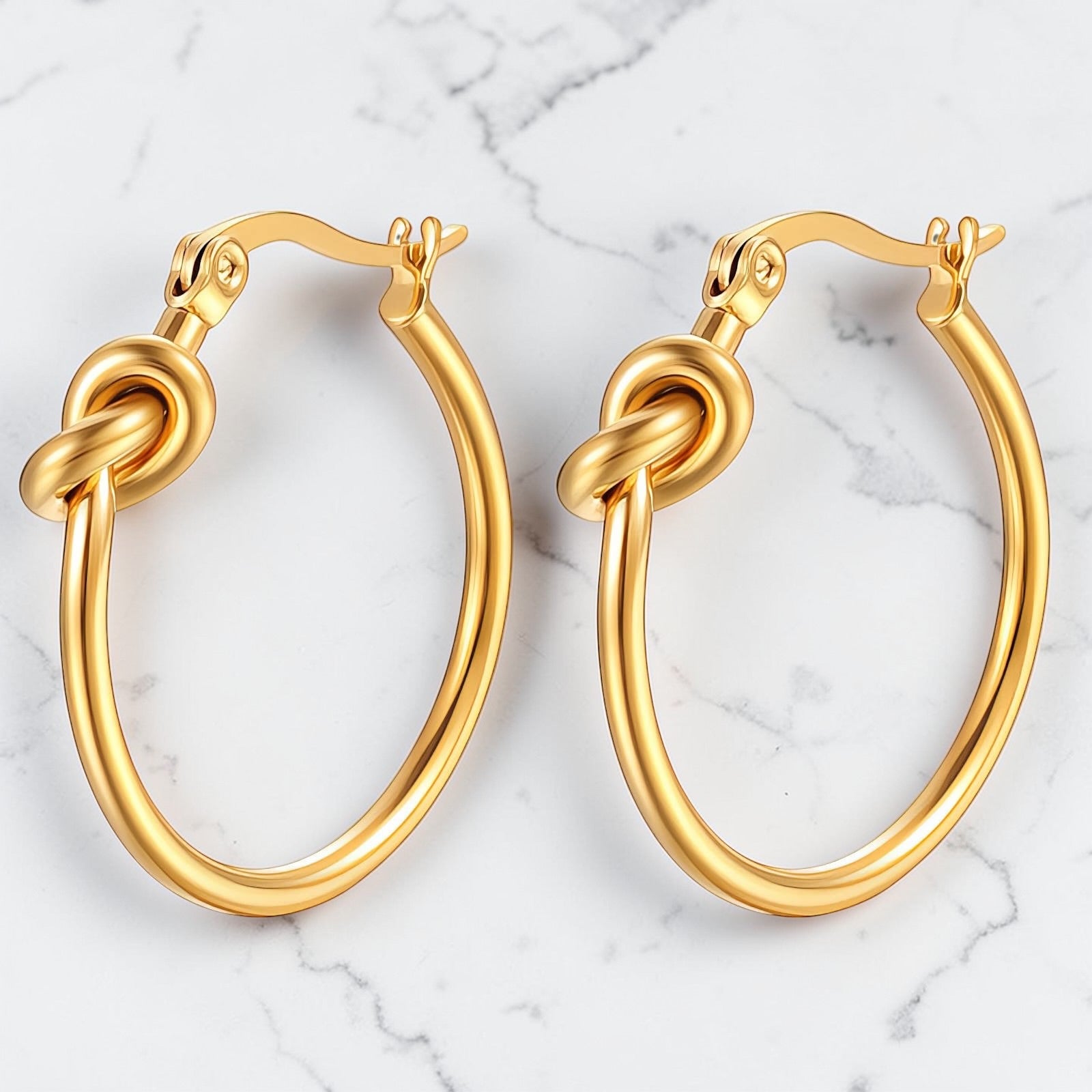 Gold hoop earrings featuring a polished infinity knot detail at the front.