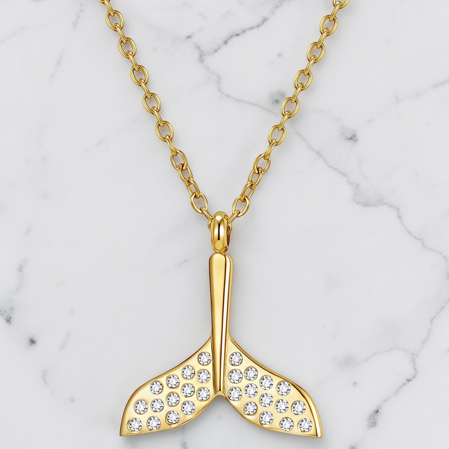Gold Lorelai necklace with cubic zirconia mermaid tail pendant on a fine chain
