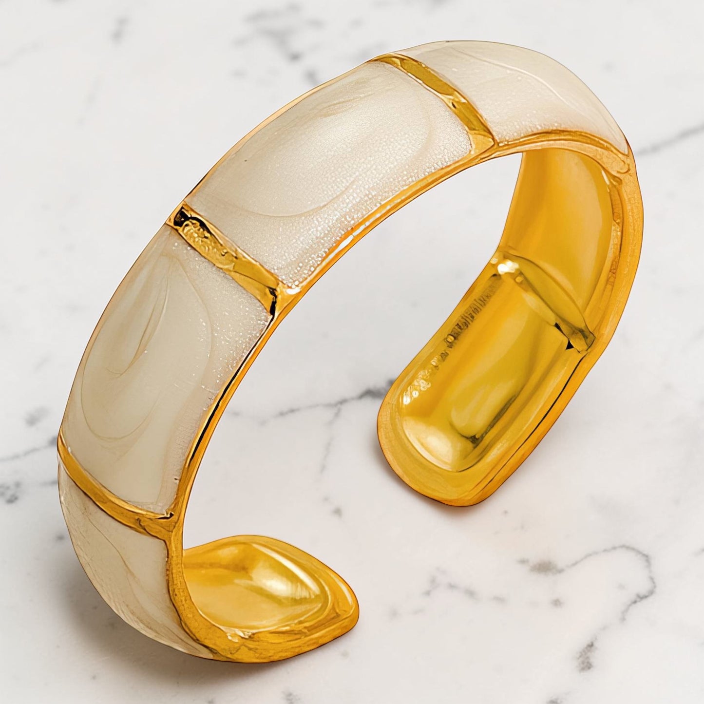 Gold-toned sculptural ring with a smooth curved open band design.