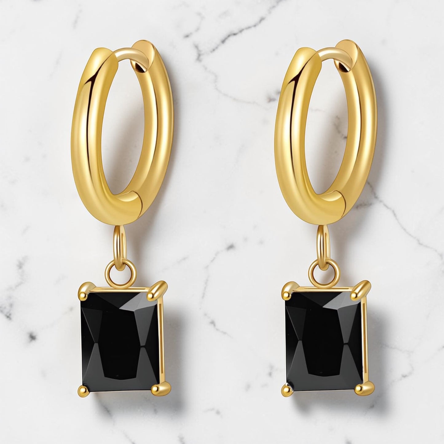 Gold hoop earrings with a black rectangular drop stone hanging from each hoop.