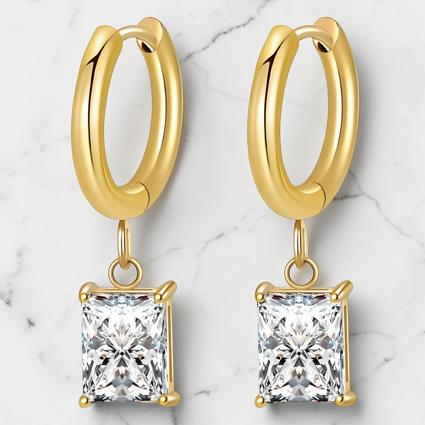 Gold hoop earrings featuring a square-cut cubic zirconia drop in a polished gold setting.
