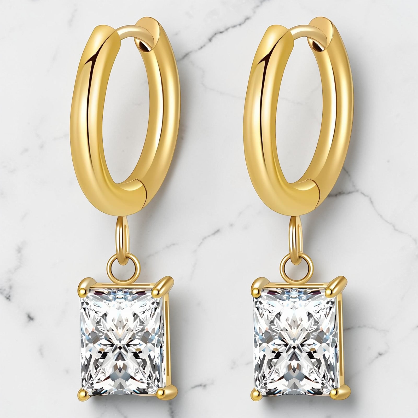 Gold hoop earrings featuring a square-cut cubic zirconia drop in a polished gold setting.
