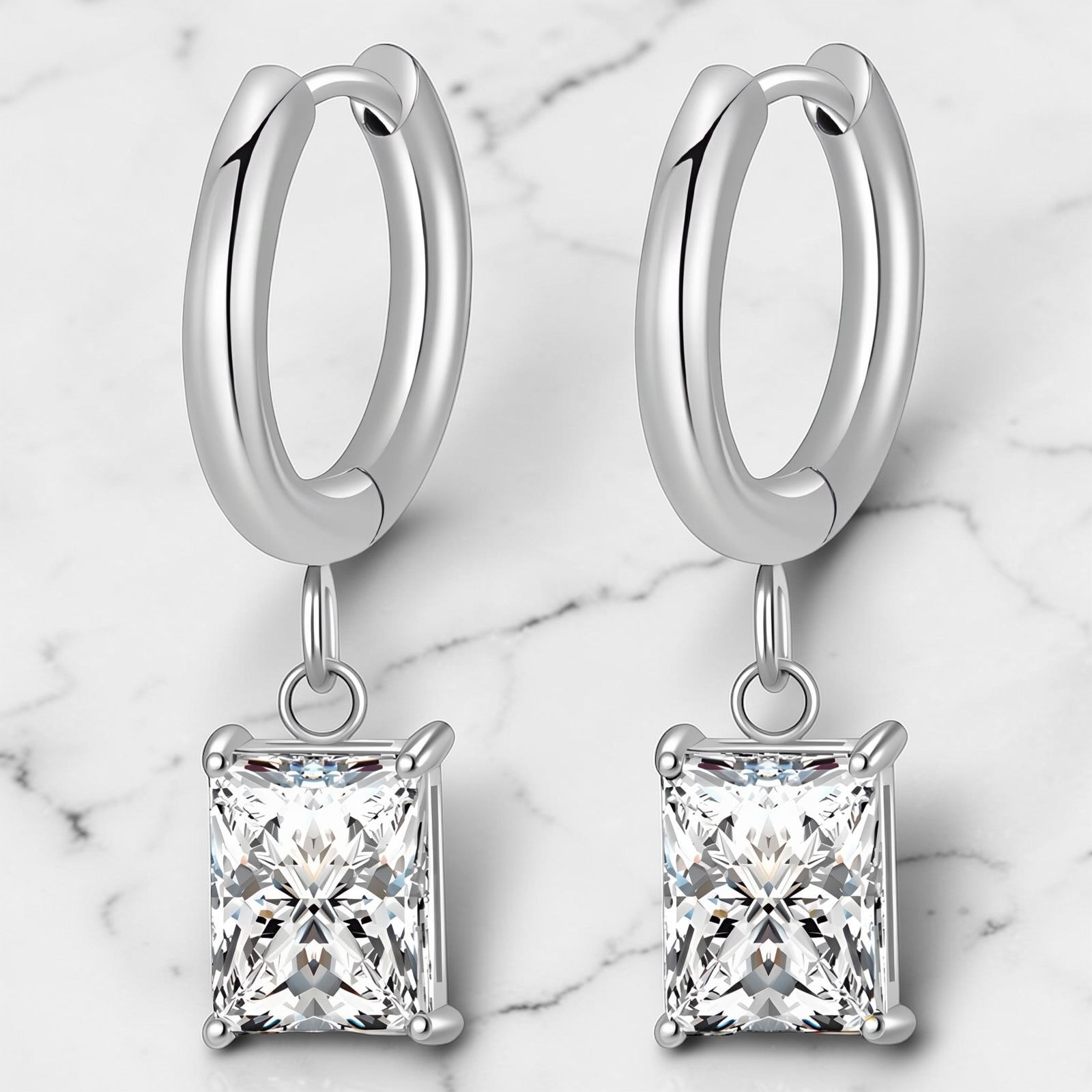 Silver hoop earrings with square-cut clear cubic zirconia drop charms.