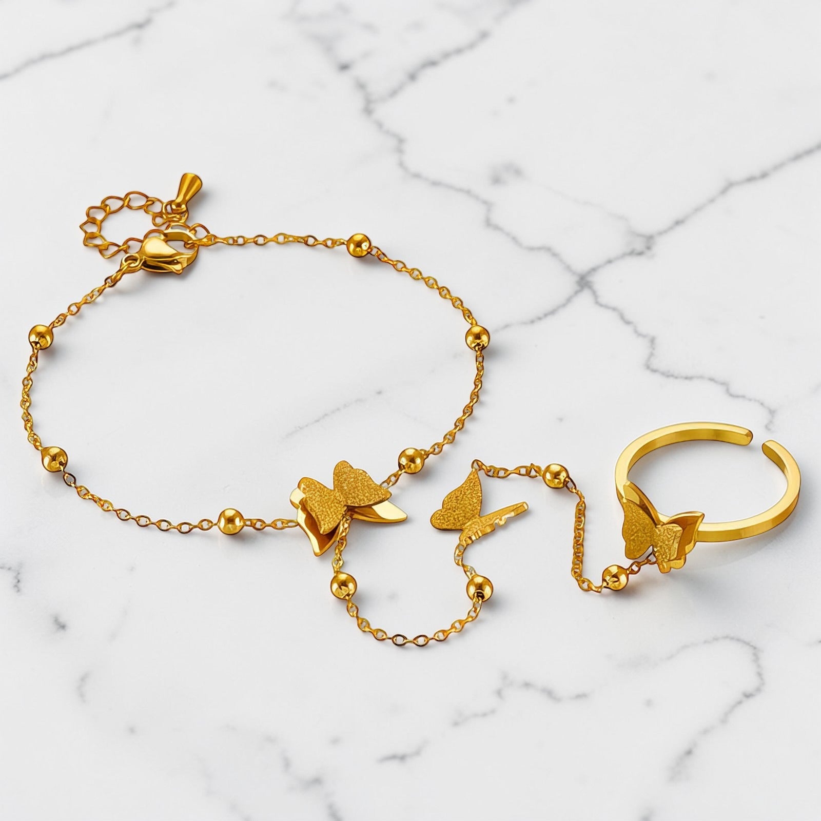 Gold butterfly jewelry set with chain bracelet and adjustable ring by Rayka & Co.