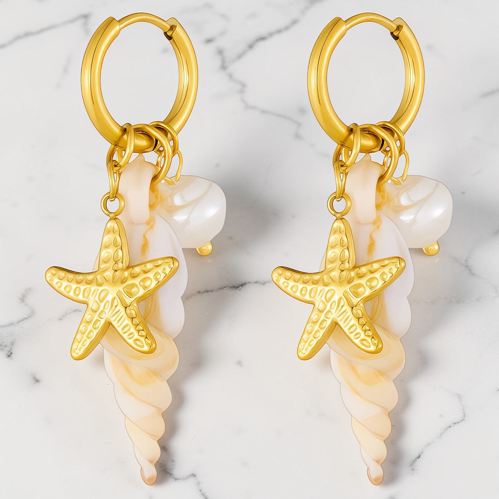 Gold pearl starfish charm hoop earrings with shell-inspired spiral charms on white background