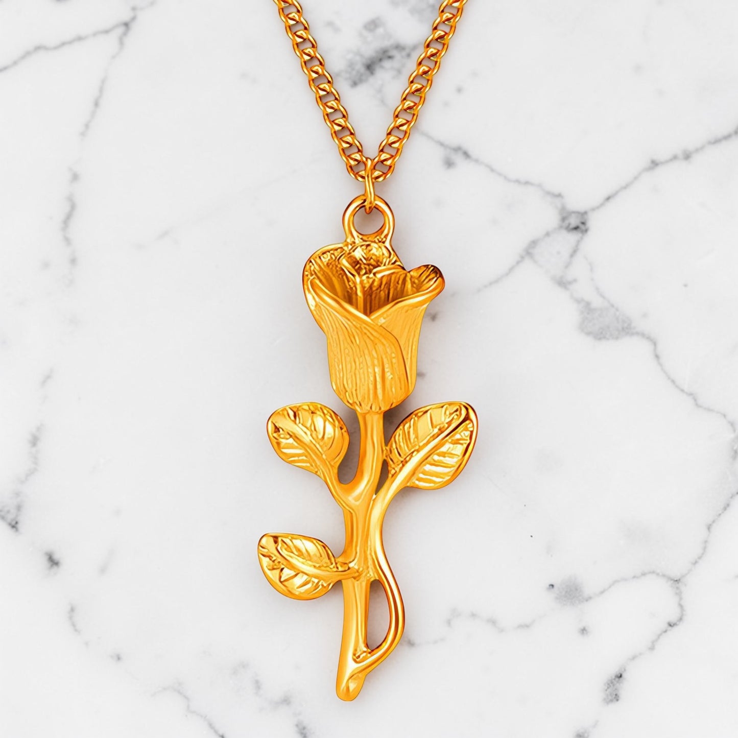 Gold rosebud pendant necklace with detailed floral design on a fine gold chain