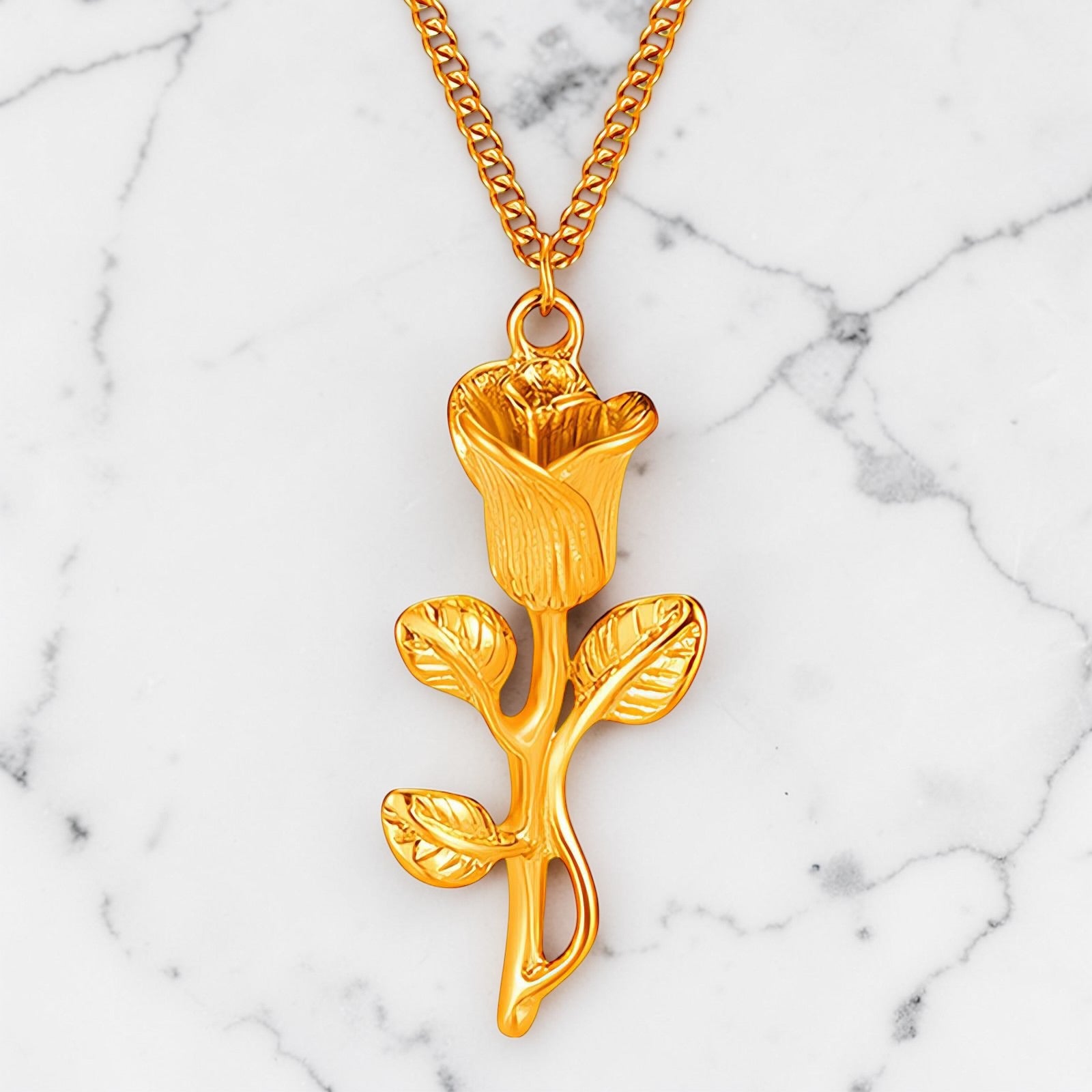 Gold rosebud pendant necklace with detailed floral design on a fine gold chain