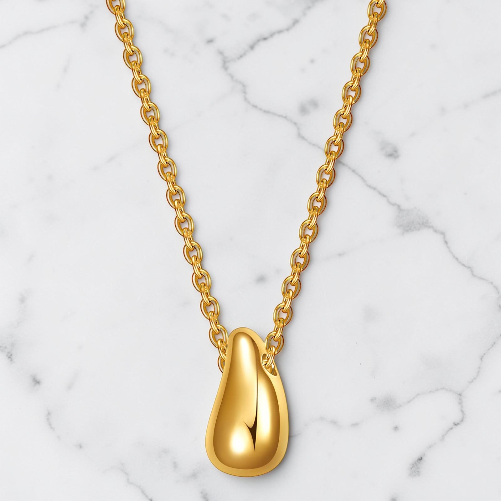 Gold drop pendant necklace with a smooth polished finish on a delicate chain