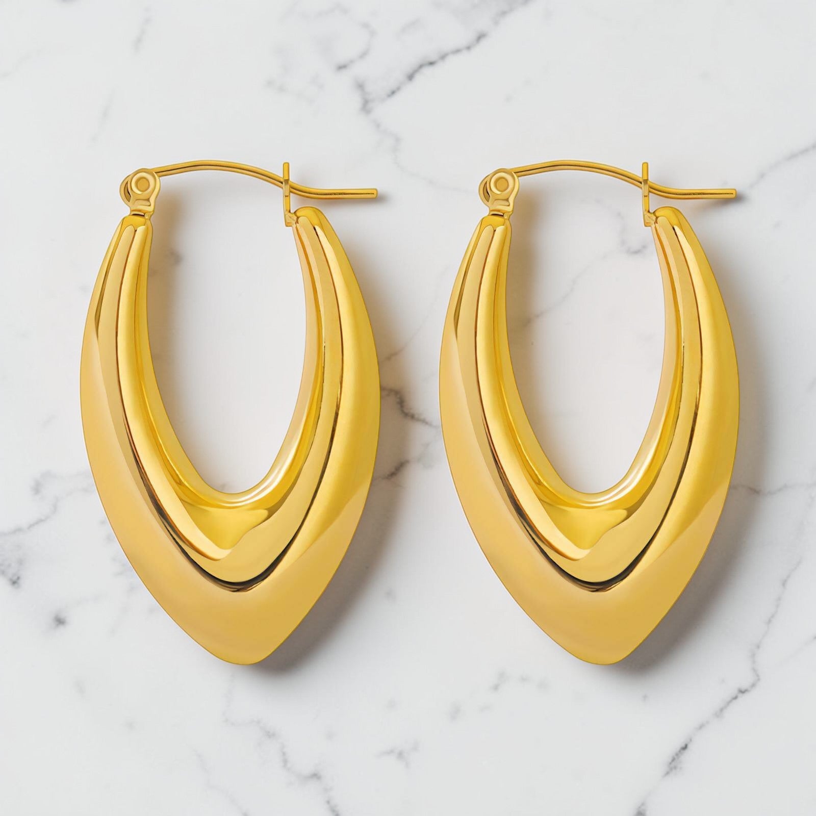 Solace gold hoops with sculpted curved design in gold-plated stainless steel