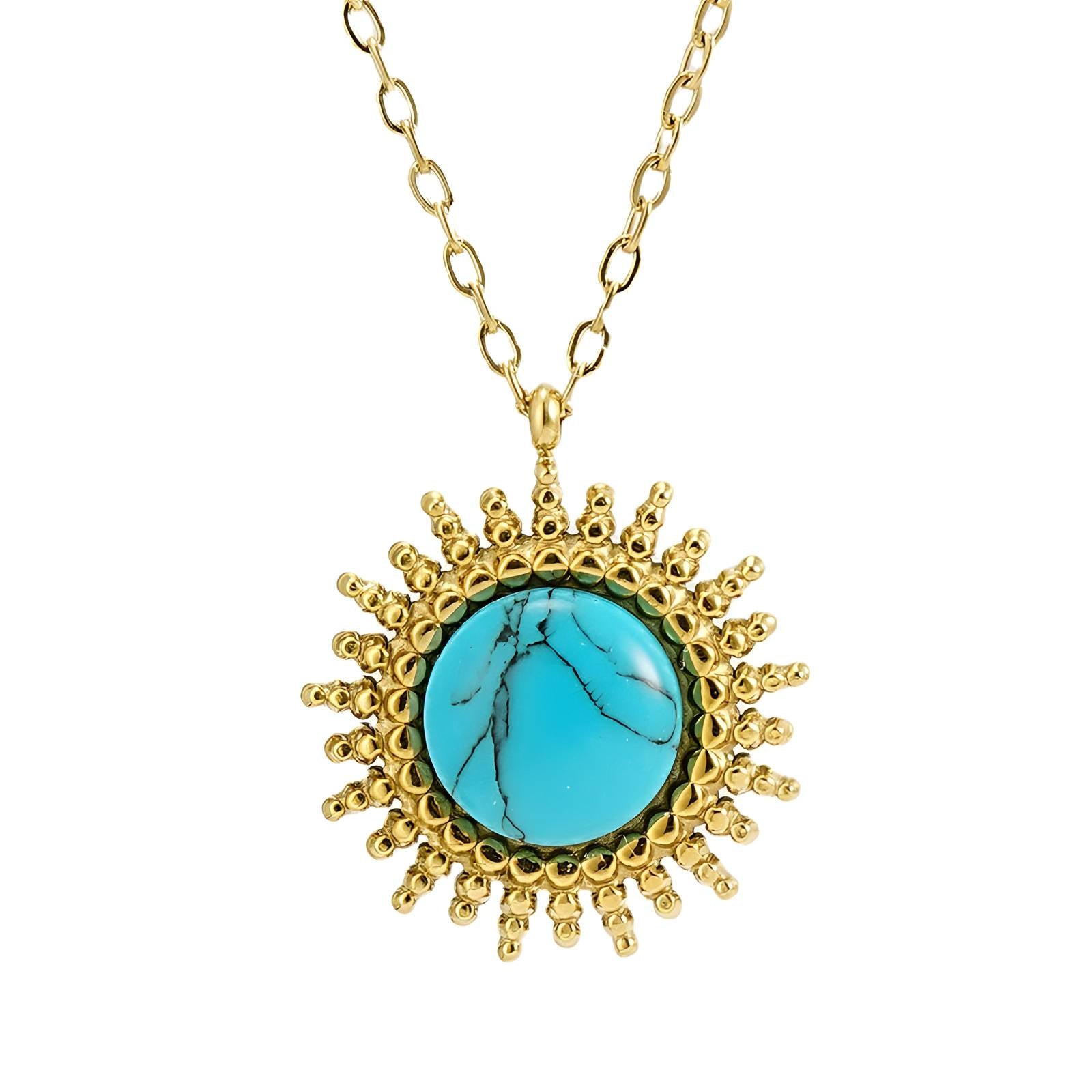 Gold sunburst pendant necklace featuring a round turquoise stone at the centre.