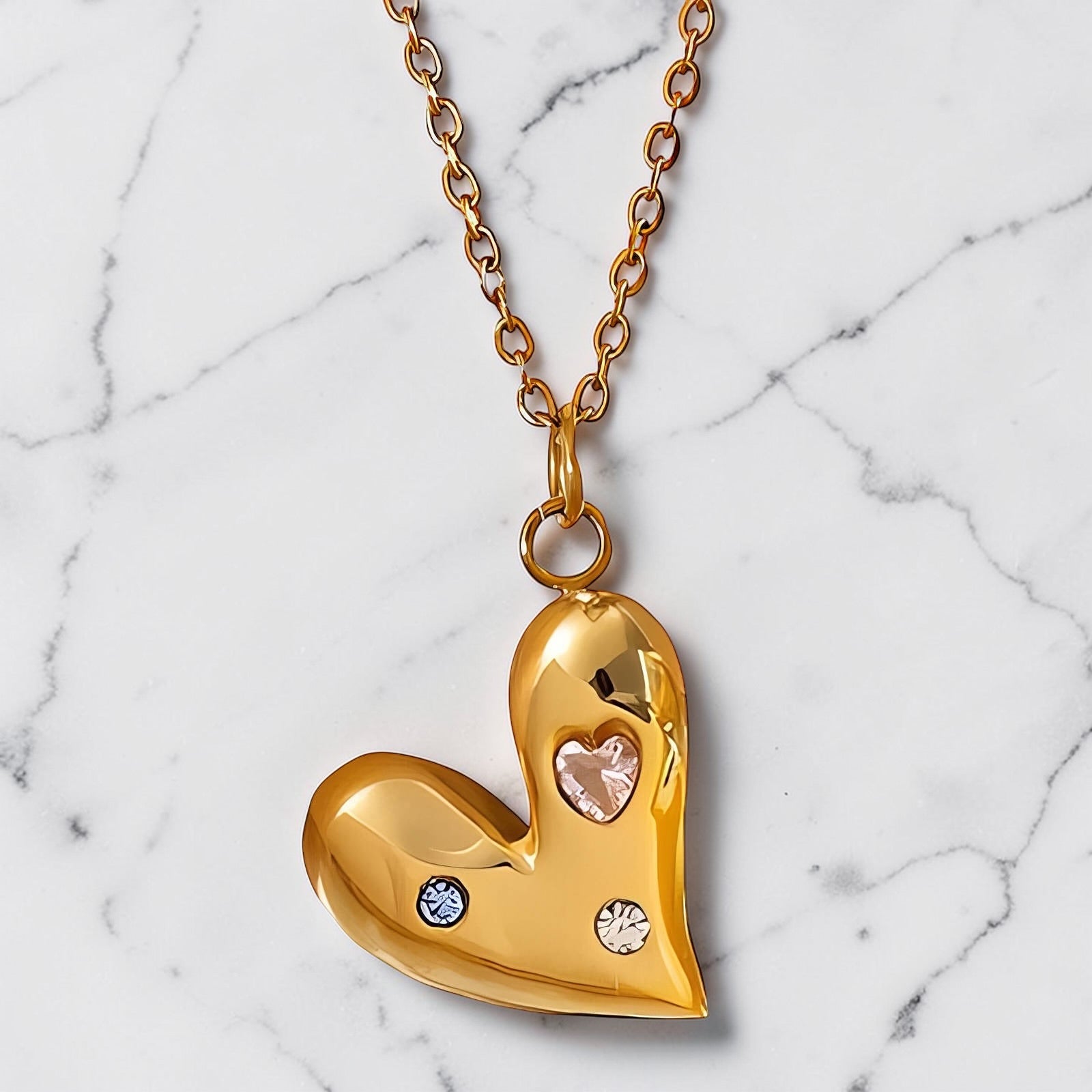 Gold heart necklace with subtle crystal accents on a fine gold chain