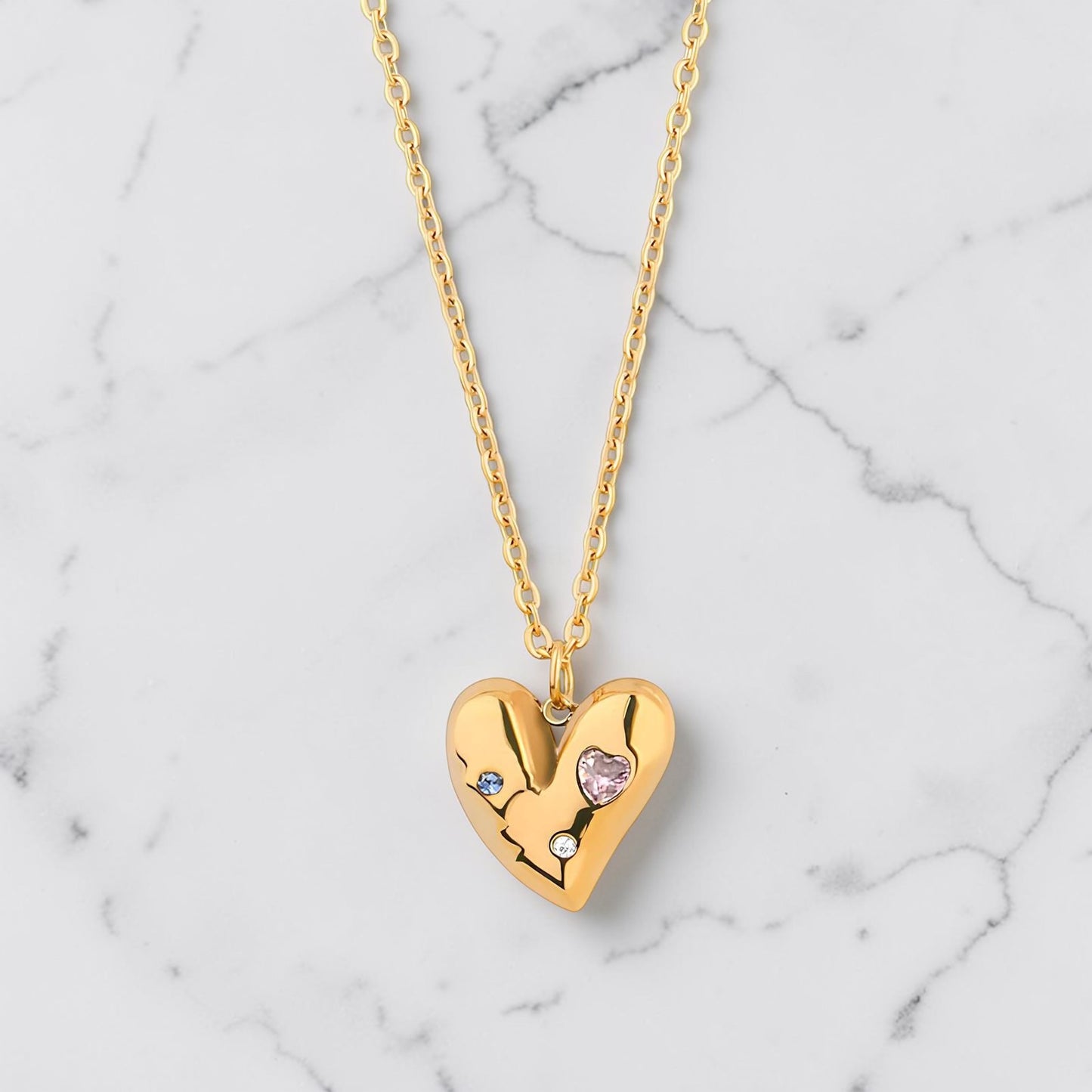 Gold heart necklace with subtle crystal accents on a fine gold chain