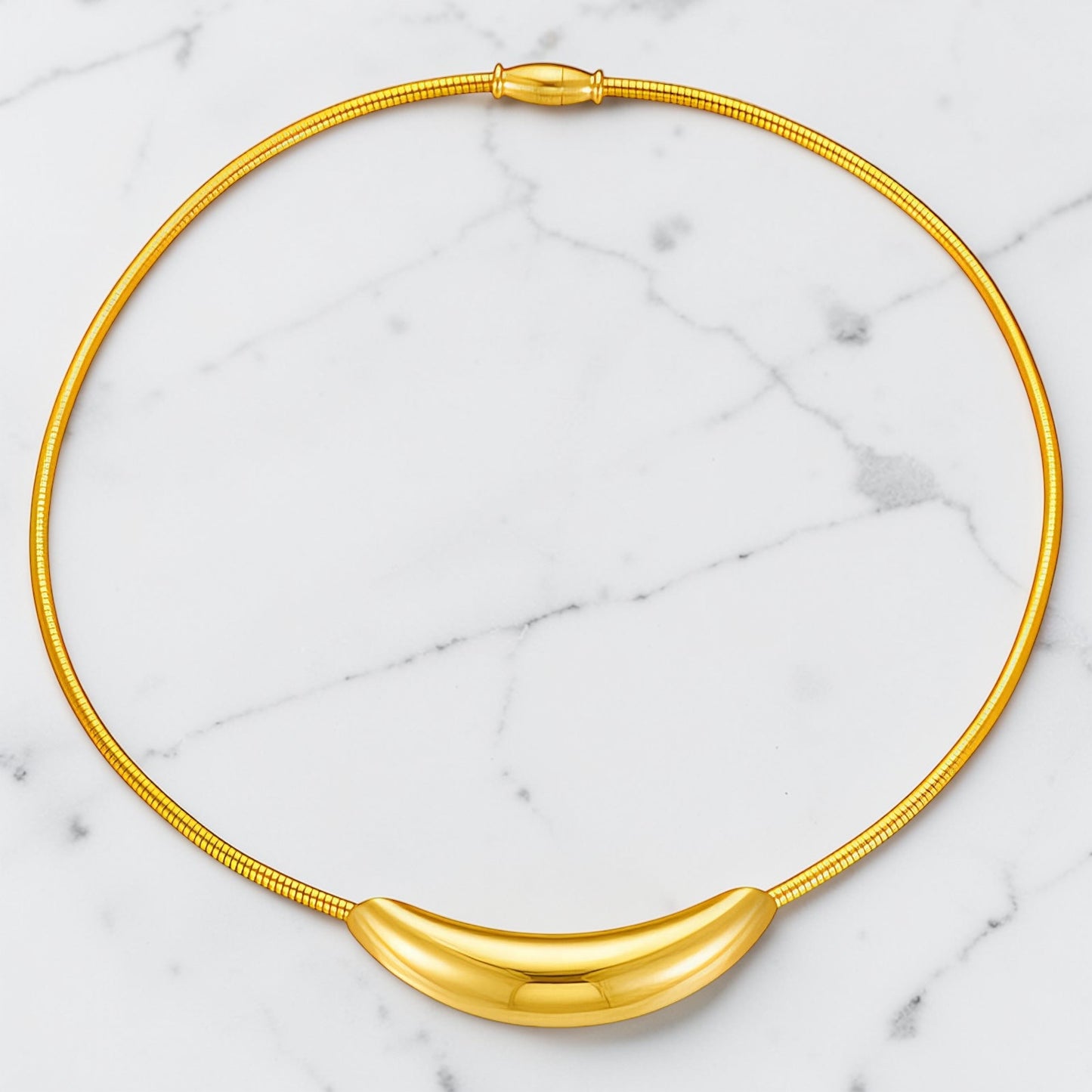 Gold-toned choker necklace with a smooth curved bar detail and magnetic closure resting along the neckline.
