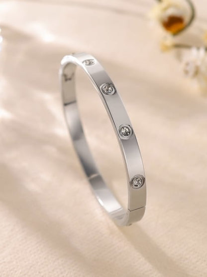 Silver-toned bangle bracelet with small crystal accents set around the band