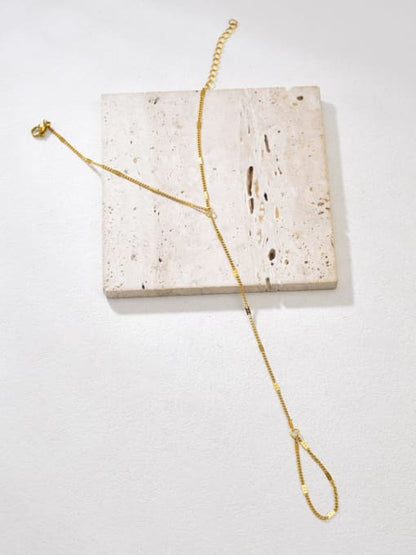 Minimal gold Mira handchain with delicate chain connecting wrist bracelet to finger loop by Rayka & Co.