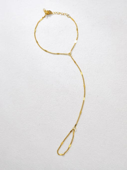 Minimal gold Mira handchain with delicate chain connecting wrist bracelet to finger loop by Rayka & Co.