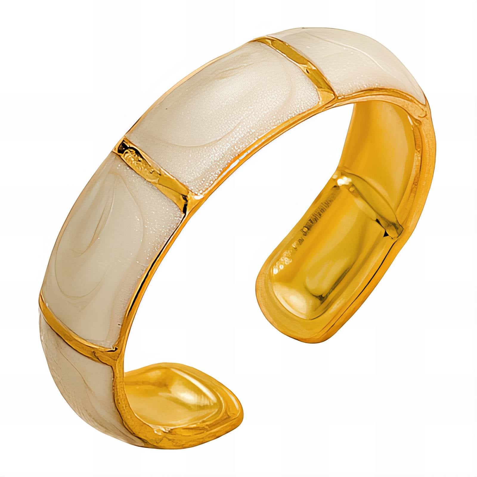 Gold-toned sculptural ring with a smooth curved open band design.