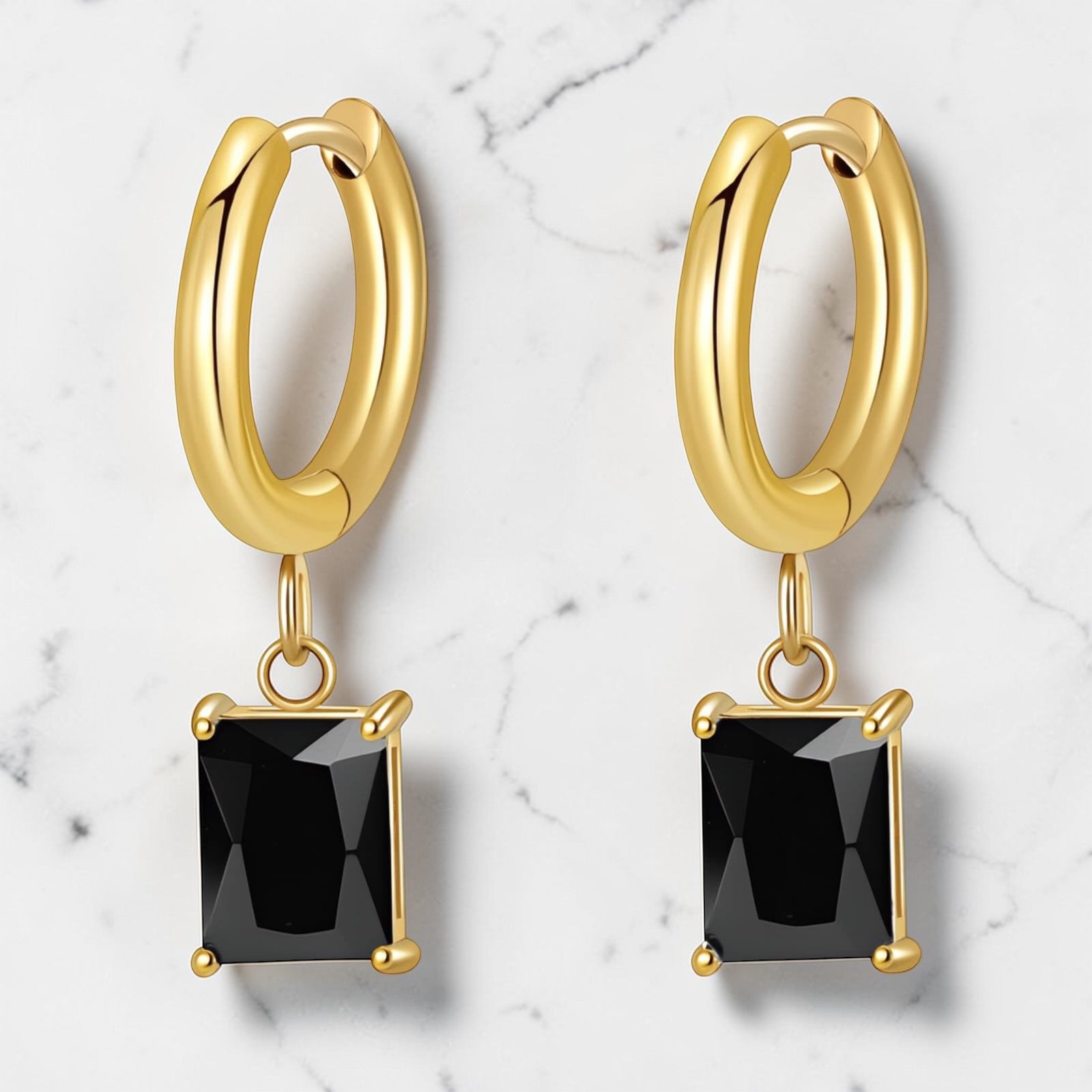 Gold hoop earrings with a black rectangular drop stone hanging from each hoop.
