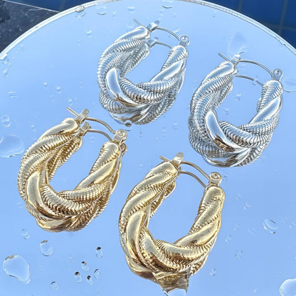 Gold twisted rope hoop earrings with textured detailing and hinged closure